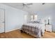 Inviting bedroom with light blue walls, wood floor, and a comfortable bed at 6948 Eagle Dr, Nineveh, IN 46164