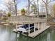 Two-story dock featuring boat lift, upper deck with patio seating and lake view at 6948 Eagle Dr, Nineveh, IN 46164