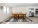 Inviting dining room with wood table and chairs, natural light, and stylish rug at 6948 Eagle Dr, Nineveh, IN 46164