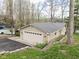 Inviting tan home featuring a large garage, a metal roof, an asphalt driveway and a small landscaped yard at 6948 Eagle Dr, Nineveh, IN 46164