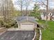 Inviting tan home featuring a large garage, a metal roof, an asphalt driveway and a small landscaped yard at 6948 Eagle Dr, Nineveh, IN 46164