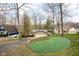 Landscaped backyard featuring a putting green, perfect for the golf enthusiast, with lovely trees at 6948 Eagle Dr, Nineveh, IN 46164