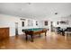 Large game room with pool table, wainscoting, and access to the dining and kitchen areas at 6948 Eagle Dr, Nineveh, IN 46164