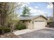 Attached garage with neutral siding, a metal roof, and driveway with side door access at 6948 Eagle Dr, Nineveh, IN 46164