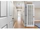 Long hallway with white doors, neutral walls, and plenty of light at 6948 Eagle Dr, Nineveh, IN 46164