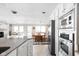 Bright kitchen with stainless steel appliances, island, and dining area with a view at 6948 Eagle Dr, Nineveh, IN 46164