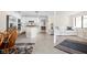 Open-concept living space with tile floors, white walls, kitchen, and large windows at 6948 Eagle Dr, Nineveh, IN 46164