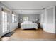 Bright main bedroom with light walls, wood floors, king bed, and access to the outside at 6948 Eagle Dr, Nineveh, IN 46164