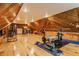 Bright and spacious attic with wood paneled walls and ceiling, and work-out equipment at 7124 Purdy St, Indianapolis, IN 46268