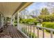 Expansive wood back deck featuring white railings and a serene view of the landscaped backyard at 7124 Purdy St, Indianapolis, IN 46268