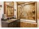 Stylish bathroom with granite countertops, a glass-enclosed shower, and a soaking tub at 7124 Purdy St, Indianapolis, IN 46268