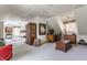 Spacious bonus room with comfortable seating, wooden accents, and carpeted floors at 7124 Purdy St, Indianapolis, IN 46268