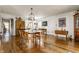 Bright dining room with hardwood floors and large wood table and chairs for gathering with friends and Gathering at 7124 Purdy St, Indianapolis, IN 46268