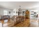 Bright dining room with hardwood floors, a wooden dining table, and white walls at 7124 Purdy St, Indianapolis, IN 46268
