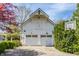 Charming barn featuring white siding, double garage doors, and a basketball hoop on the side at 7124 Purdy St, Indianapolis, IN 46268