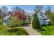 Exterior view of home and barn with lush landscaping, trees, and a circular driveway at 7124 Purdy St, Indianapolis, IN 46268