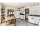 Bright and sunny eat in kitchen area with white cabinets, stainless steel appliances, and eat in dining area at 7124 Purdy St, Indianapolis, IN 46268