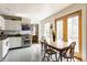 White kitchen area with stainless steel appliances and eat in breakfast area with glass doors leading to outside at 7124 Purdy St, Indianapolis, IN 46268