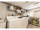 Functional laundry room equipped with a washer, dryer, and ample storage shelves at 7124 Purdy St, Indianapolis, IN 46268