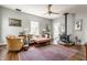 Cozy living room featuring a wood burning stove, hardwood floors, and lots of natural light from the windows at 7124 Purdy St, Indianapolis, IN 46268