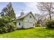 Charming outbuilding on a lush green lawn with mature trees in the background at 7124 Purdy St, Indianapolis, IN 46268