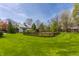 Expansive backyard with green grass, landscaping, and an outbuilding at 7124 Purdy St, Indianapolis, IN 46268