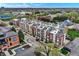 Aerial view showcases modern townhomes with rooftop decks, street parking, and lush green surroundings at 741 Bates St, Indianapolis, IN 46202