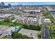 Aerial view shows a mixed-use development with townhomes and condos near green spaces, roads, and amenities at 741 Bates St, Indianapolis, IN 46202