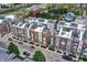 Aerial view of townhomes featuring rooftop decks, manicured trees, and neighborhood streetscape with parking at 741 Bates St, Indianapolis, IN 46202