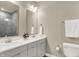 Modern bathroom with double vanity, bright mirror, and adjacent toilet at 741 Bates St, Indianapolis, IN 46202