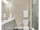 Stylish bathroom includes a modern toilet, white towel, and glass shower enclosure at 741 Bates St, Indianapolis, IN 46202