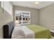 Cozy bedroom filled with natural light, featuring a large window and comfortable bedding at 741 Bates St, Indianapolis, IN 46202