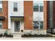 Attractive townhome entrance featuring a decorative wreath, seasonal plantings, and brick and siding accents at 741 Bates St, Indianapolis, IN 46202