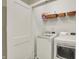 Efficient laundry room featuring modern washer and dryer units, storage shelves, and a clean, organized layout at 741 Bates St, Indianapolis, IN 46202