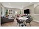 Living room with a large window, gray sofa, wood flooring, and neutral walls at 741 Bates St, Indianapolis, IN 46202