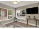 Cozy living room with neutral tones, a flat-screen TV, stylish decor, and hardwood floors at 741 Bates St, Indianapolis, IN 46202