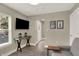 Cozy living room with neutral tones, a flat-screen TV, stylish decor, and hardwood floors at 741 Bates St, Indianapolis, IN 46202