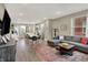 Open-concept living room with modern gray sofa, area rug, and dining space at 741 Bates St, Indianapolis, IN 46202