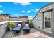 Enjoy relaxing on this rooftop deck with outdoor seating, potted plants, and stylish decor under a sunny sky at 741 Bates St, Indianapolis, IN 46202