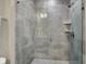 Sleek glass shower with tiled walls, built-in shelving, and updated fixture at 741 Bates St, Indianapolis, IN 46202