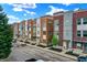 Charming townhomes along a street, featuring varied facades, landscaping, and convenient parking spots at 741 Bates St, Indianapolis, IN 46202