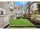 Landscaped backyard has a stone tiled patio, lawn, wood fence, and a grill at 7613 W Stonegate Dr, Zionsville, IN 46077