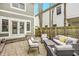 Backyard patio features a stone tile, with white cushions on the wicker chairs and sofa at 7613 W Stonegate Dr, Zionsville, IN 46077