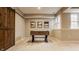 Bright basement featuring a foosball table, natural light from multiple windows, and rustic barn door at 7613 W Stonegate Dr, Zionsville, IN 46077