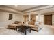 Spacious basement with stylish furniture, including a plush sofa and a rustic wood accent wall at 7613 W Stonegate Dr, Zionsville, IN 46077