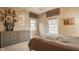 Neutral bedroom features a gray dresser, open shelving, and natural light from two windows at 7613 W Stonegate Dr, Zionsville, IN 46077