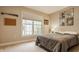 Cozy bedroom filled with decor, a window with blinds, and carpet flooring which allows an abundance of natural light at 7613 W Stonegate Dr, Zionsville, IN 46077