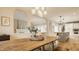 Open dining and living area with hardwood floors, white trim, and modern decor at 7613 W Stonegate Dr, Zionsville, IN 46077