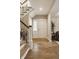 Bright entryway with hardwood floors, stairs, and natural light from the sidelight window at 7613 W Stonegate Dr, Zionsville, IN 46077