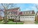 Beautiful home with well-kept lawn and landscaping, mature trees, and a spacious three-car garage at 7613 W Stonegate Dr, Zionsville, IN 46077